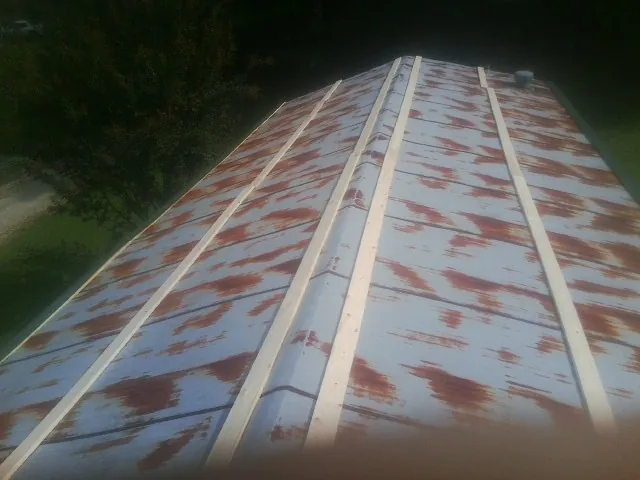 Rusted metal roof panels with new wood purlins before replacement — Storm Damage Roof Repair in Watsonville by Roofing Brothers