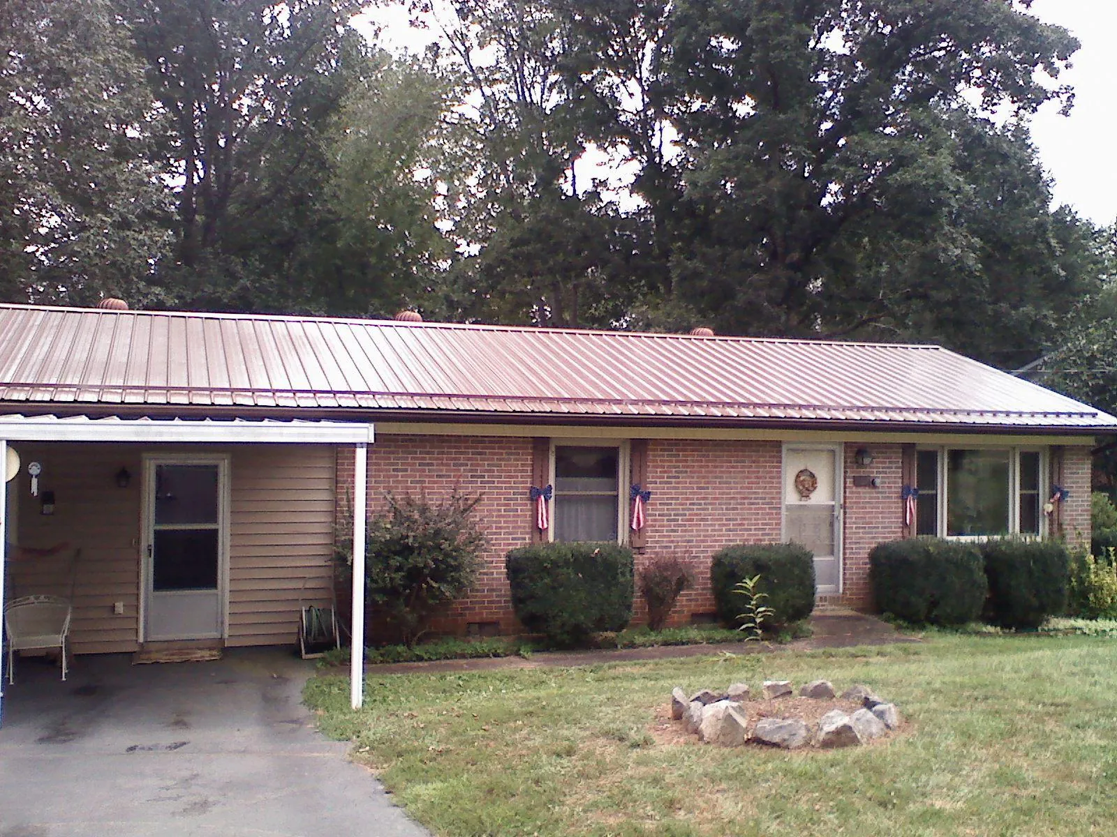 Bronze metal roof and carport on a brick ranch home — Roof Repair work by our crew in Watsonville